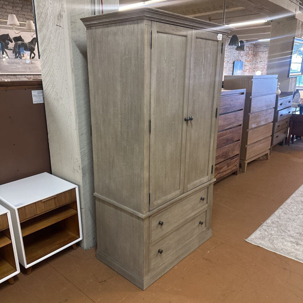 Wooden wardrobe with two doors and two drawers in a store setting
