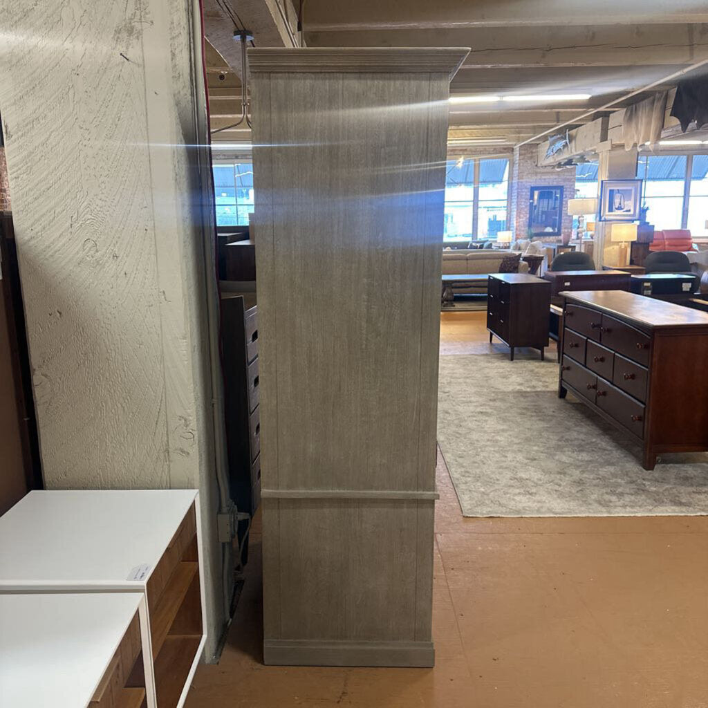 Wooden panel in a furniture store with various items in the background