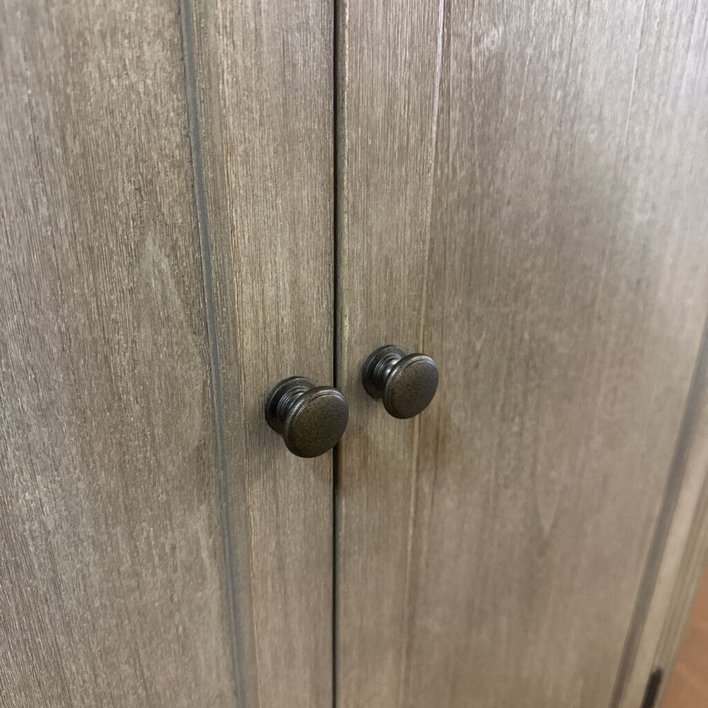 Wooden cabinet with two knobs on a wooden surface