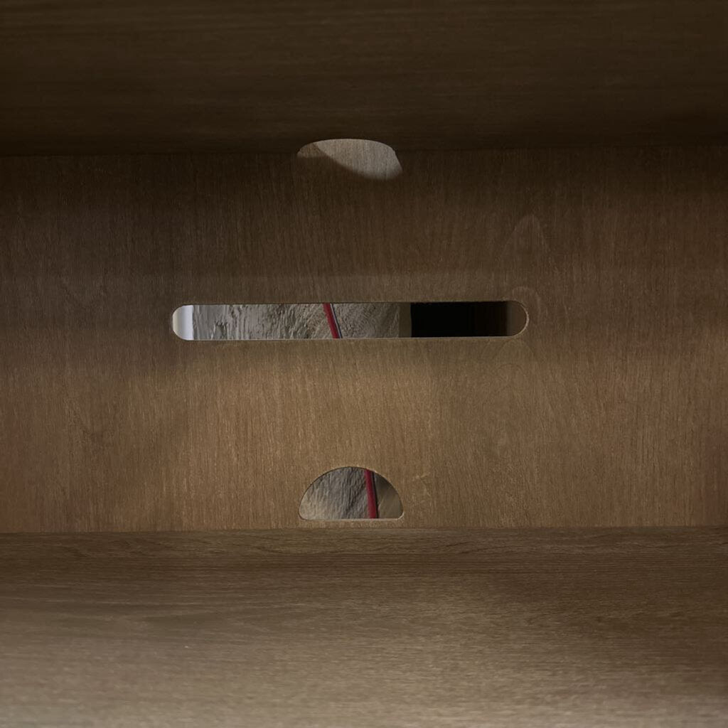 Close-up of a brown cardboard box with cut-out handles.