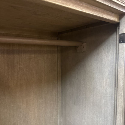 Close-up of a wooden shelf corner with a metal bracket.