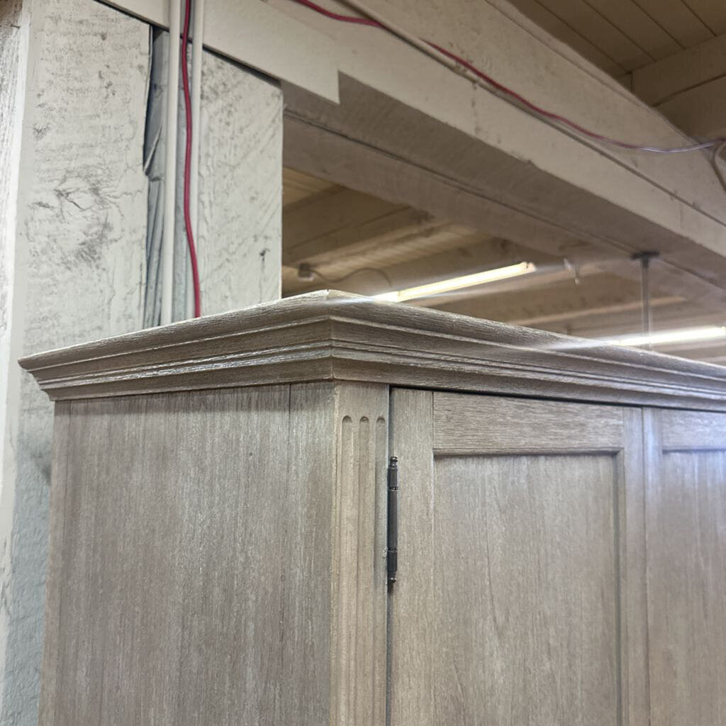 Wooden cabinet with a decorative trim in a workshop setting