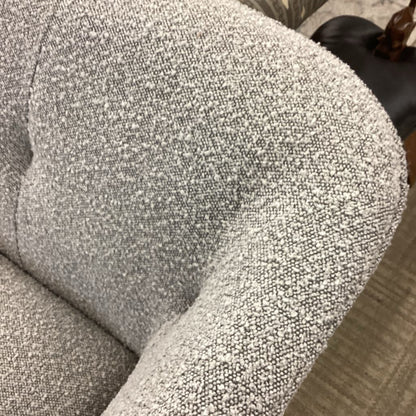 Close-up of a textured gray sofa armrest