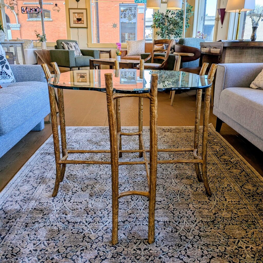 High-top dining table with wooden chairs in a living room setting.