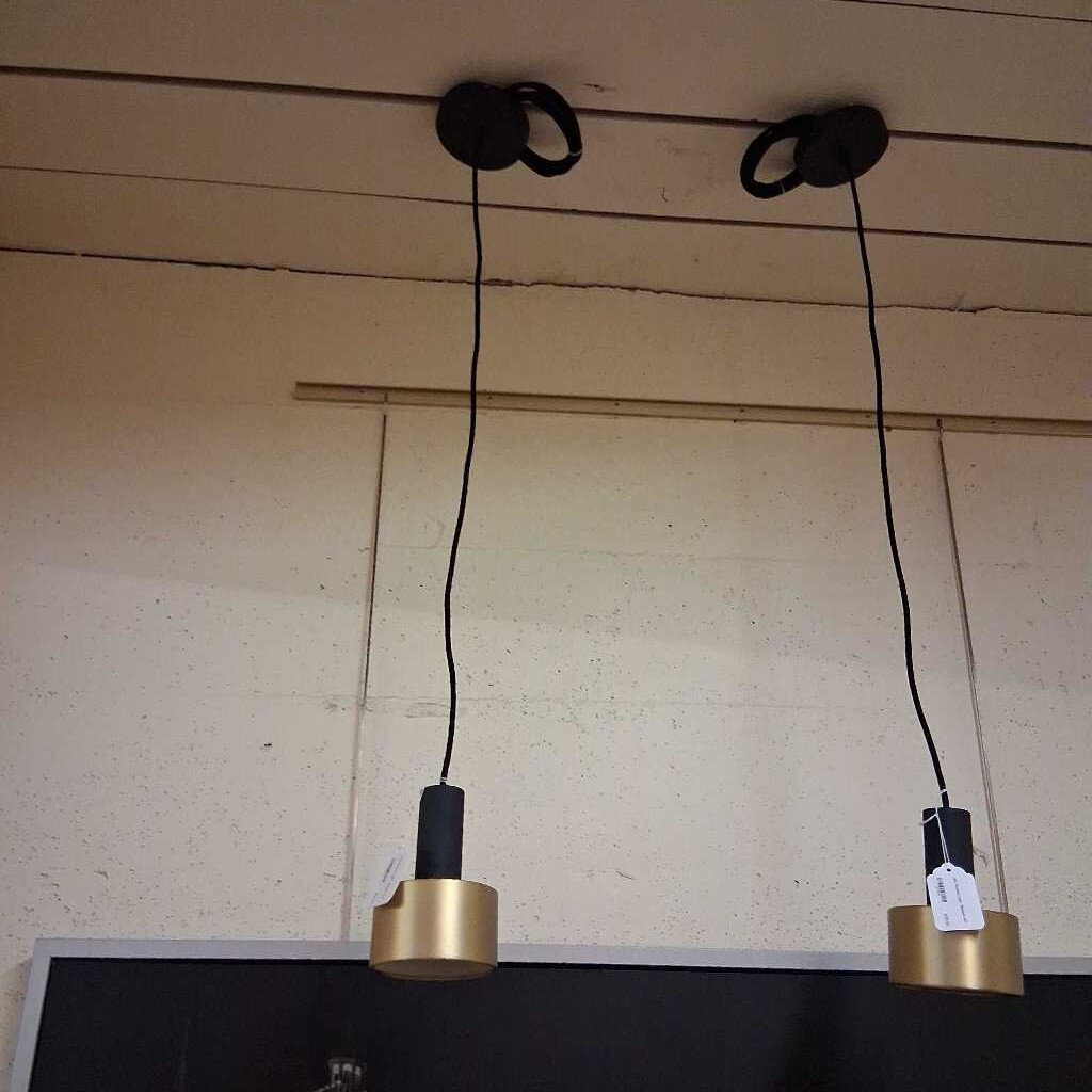 Two gold pendant lights hanging from the ceiling with visible wiring.