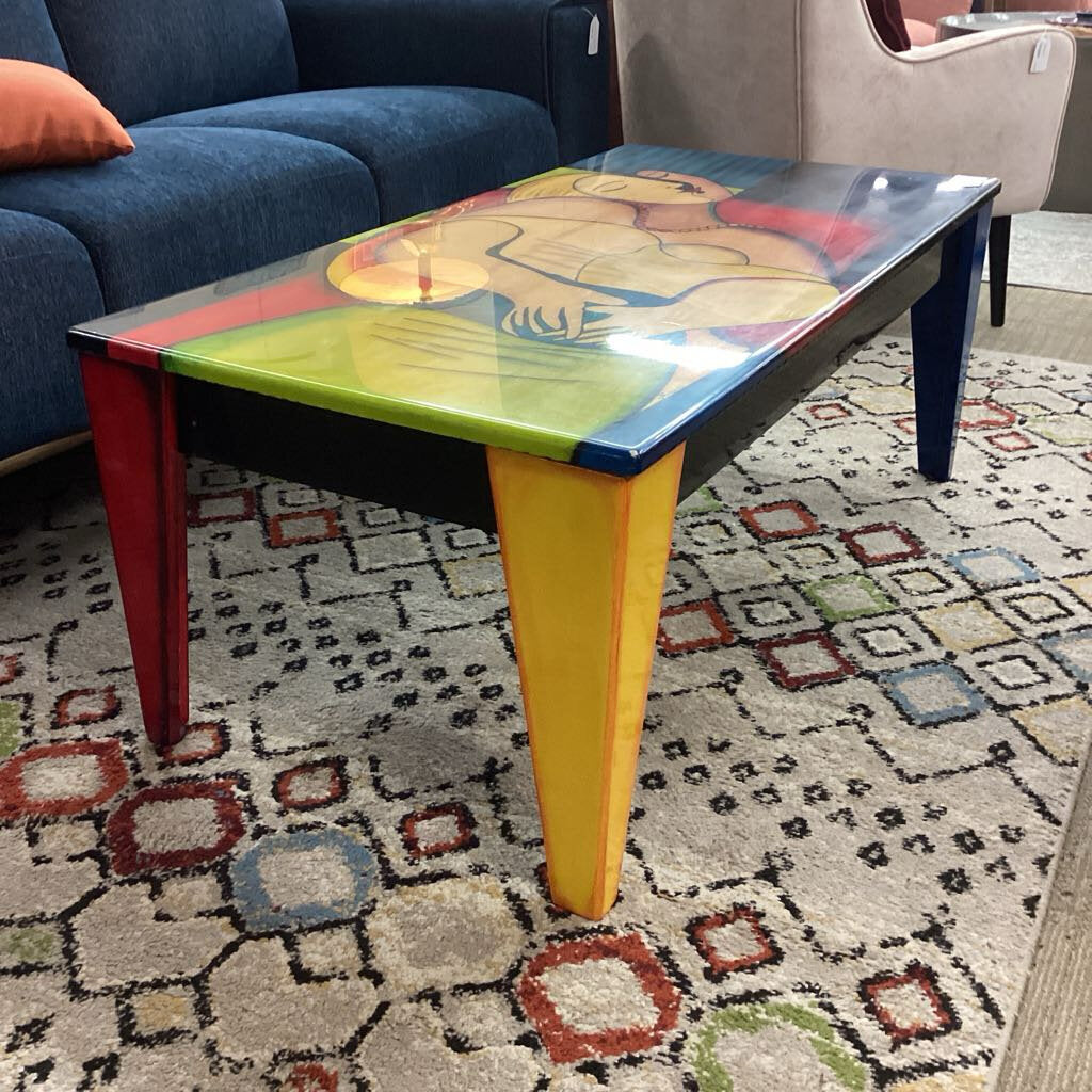 Colorful coffee table with abstract design on a patterned rug