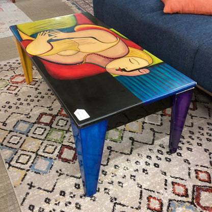 Colorful table with artistic design on a patterned rug