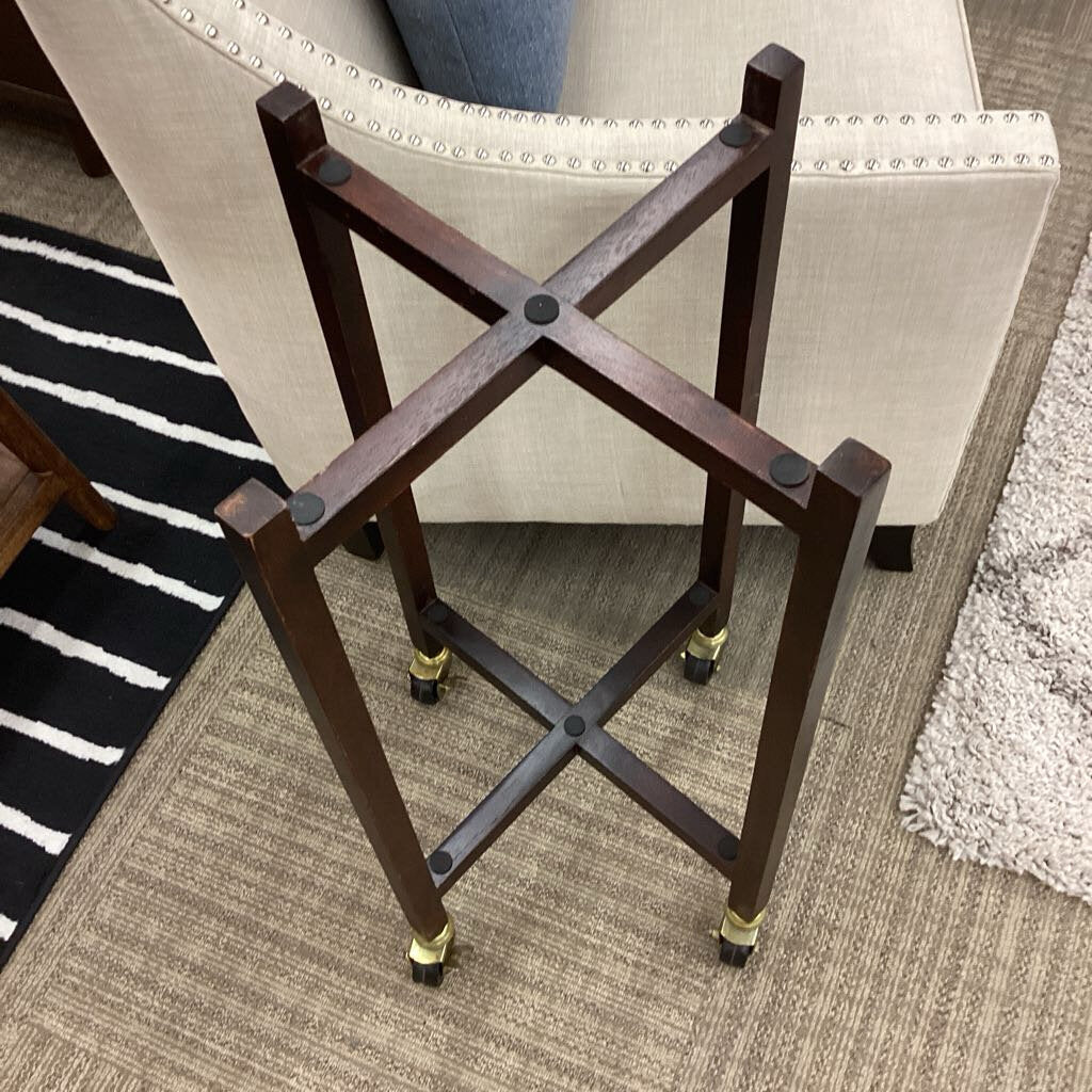Wooden stand with X-shaped design on a carpeted floor