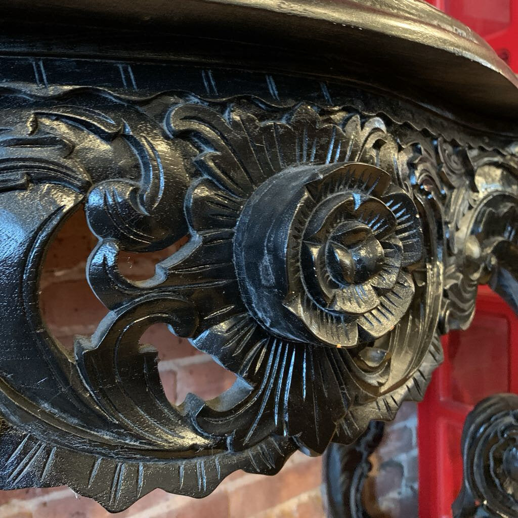 Decorative metal design with intricate patterns on a red background