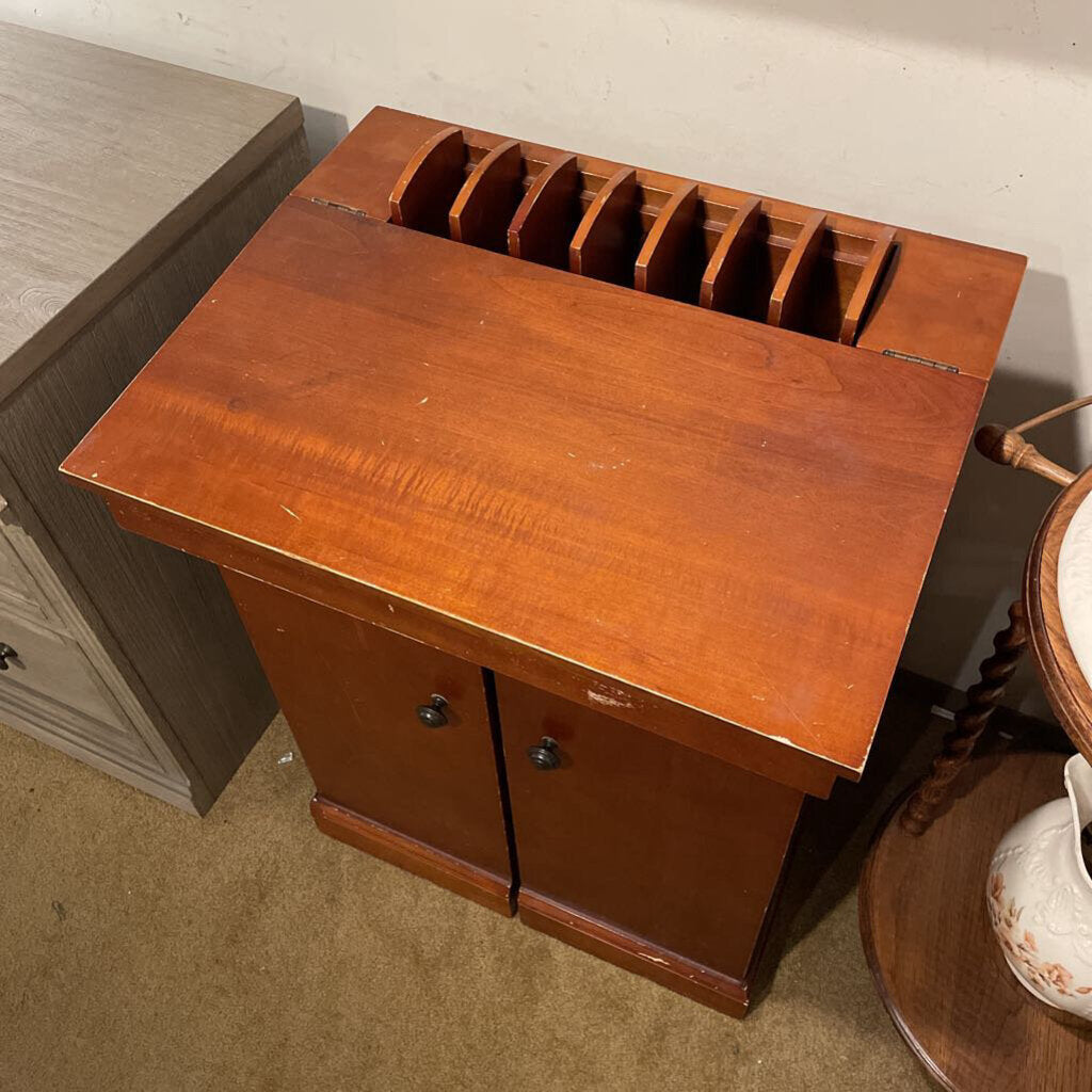 Wooden letter holder with multiple compartments on a wooden surface.