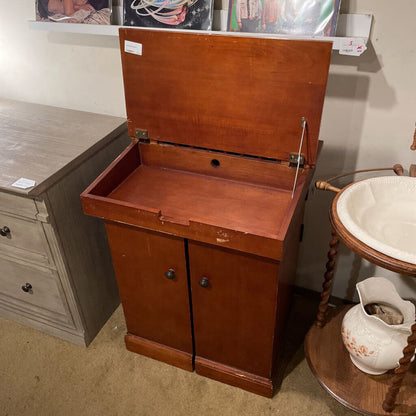 Wooden cabinet with open lid in a room with furniture and decor