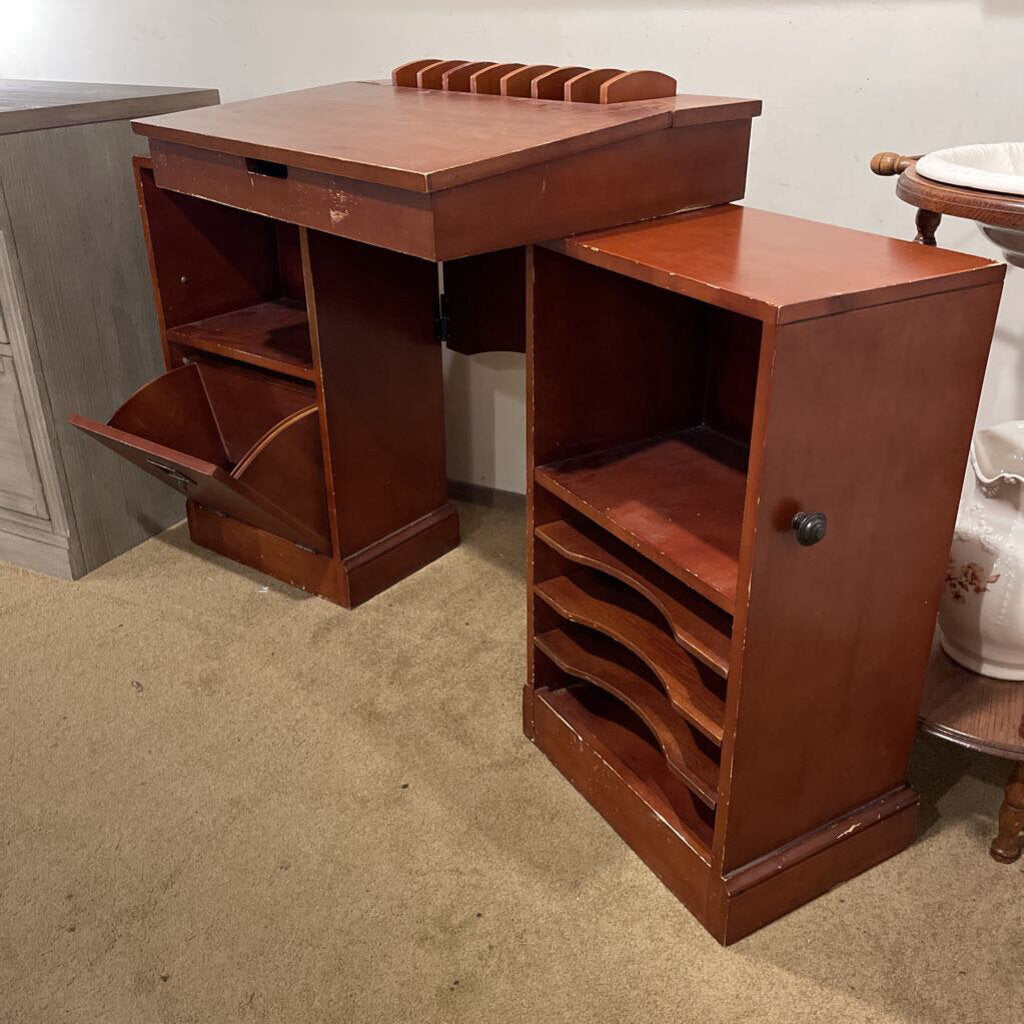 Wooden desk with open drawers in a room setting