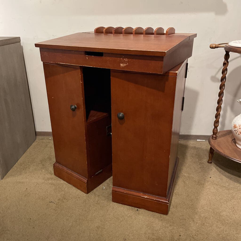 Wooden cabinet with open door on a carpeted floor