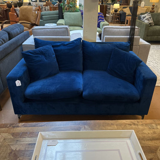 Blue sofa with cushions in a furniture store setting