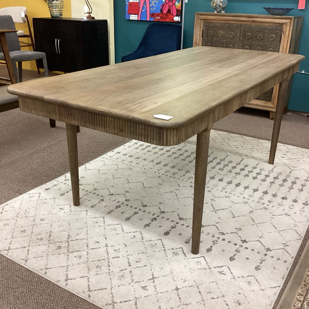 Wooden dining table in a room with furniture and decor