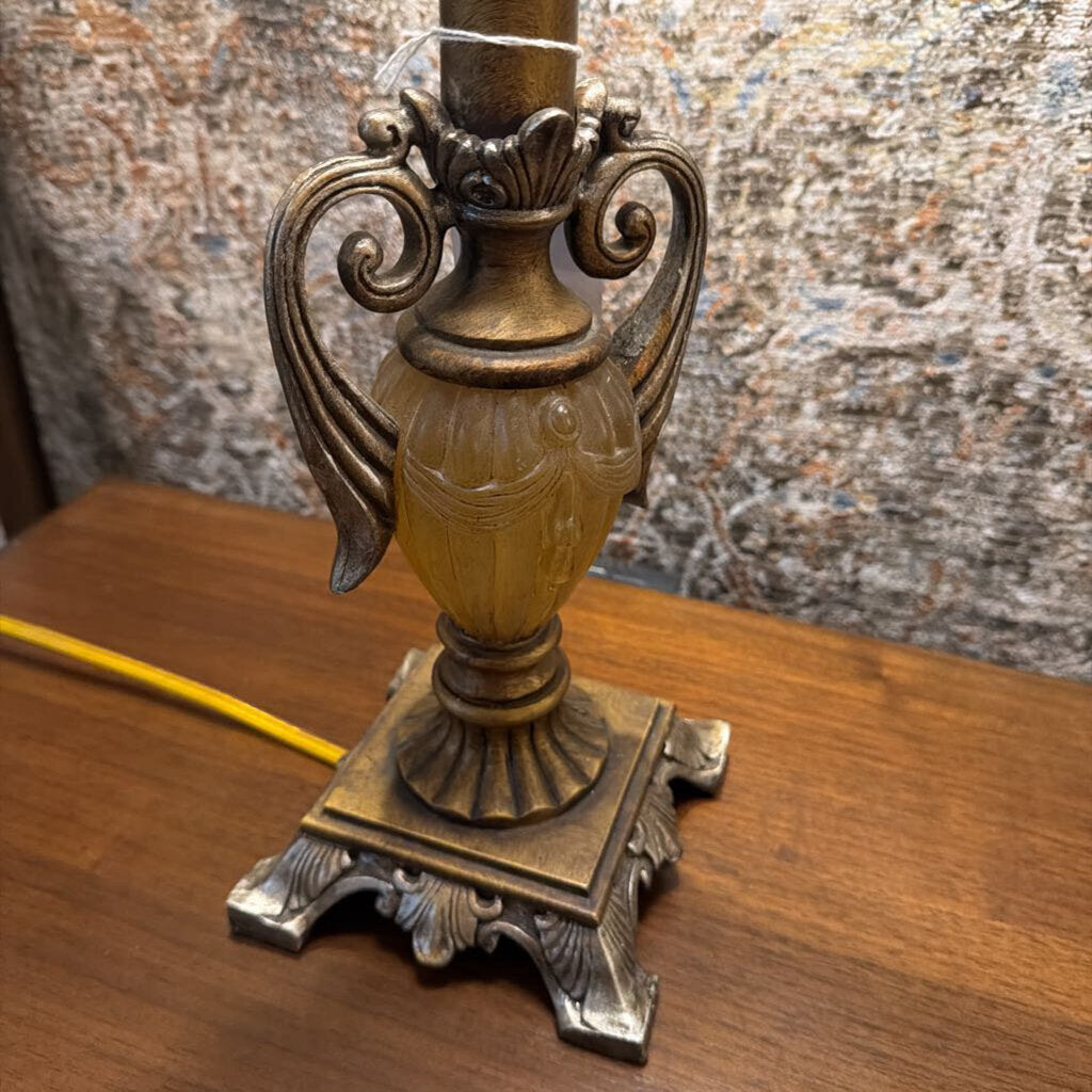 Decorative lamp with intricate design on a wooden surface