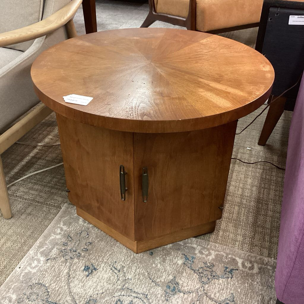 Wooden round table with a cabinet base on a patterned rug