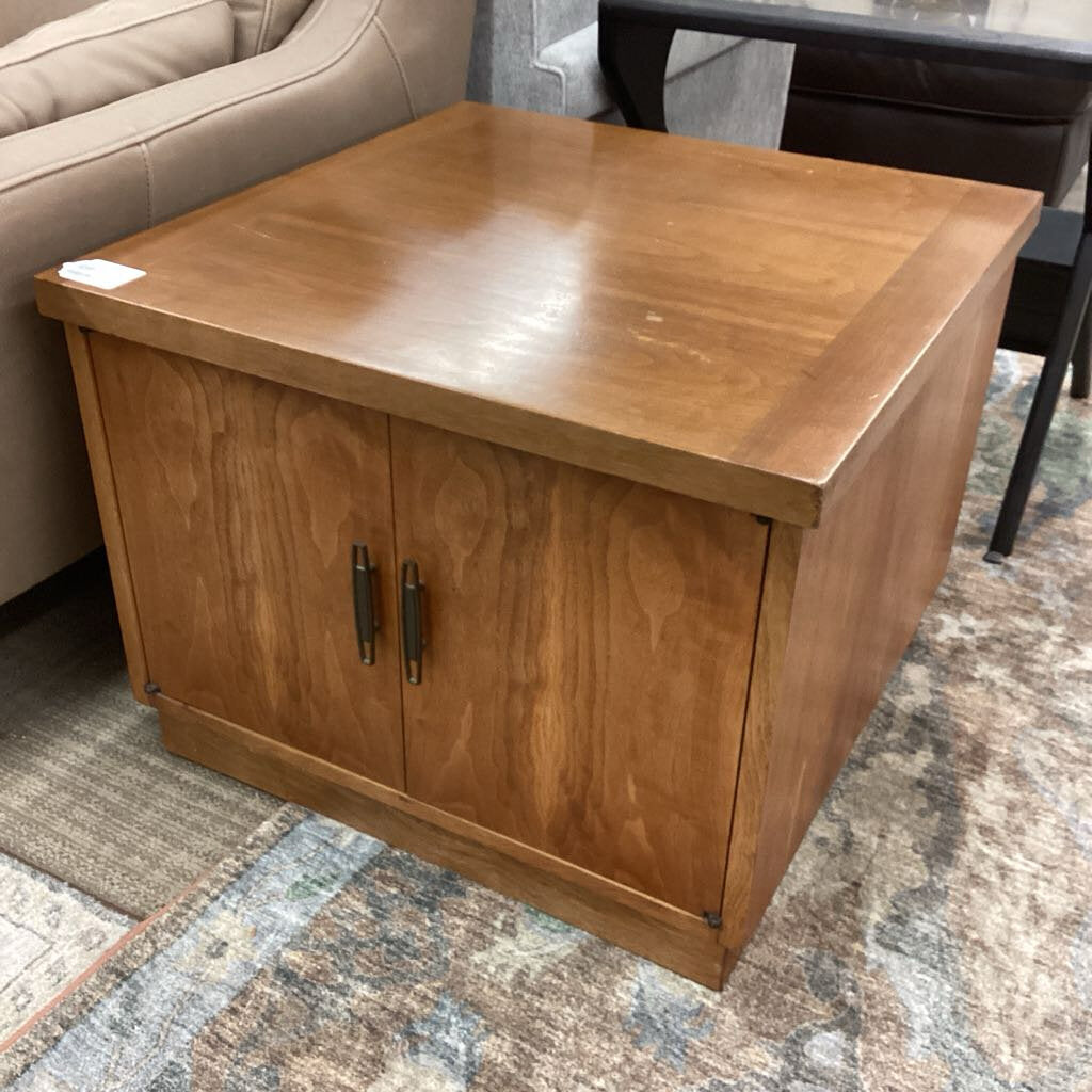 Wooden side table with two doors in a room setting