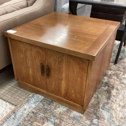 Wooden side table with two doors in a room setting