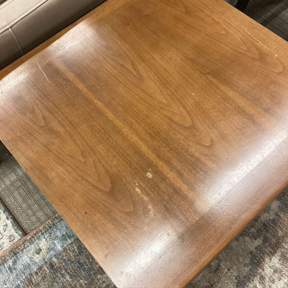 Wooden table with a brown finish on a textured surface