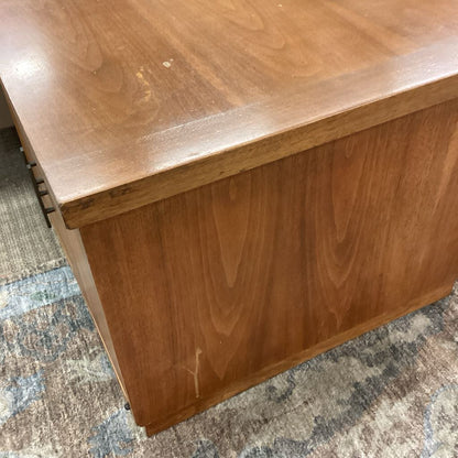 Wooden desk corner on a patterned carpet