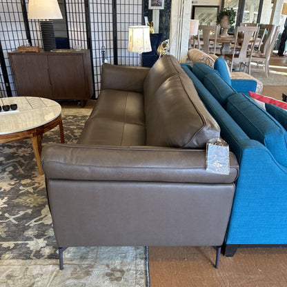 Gray sofa and blue couch in a room with a rug and lamp.