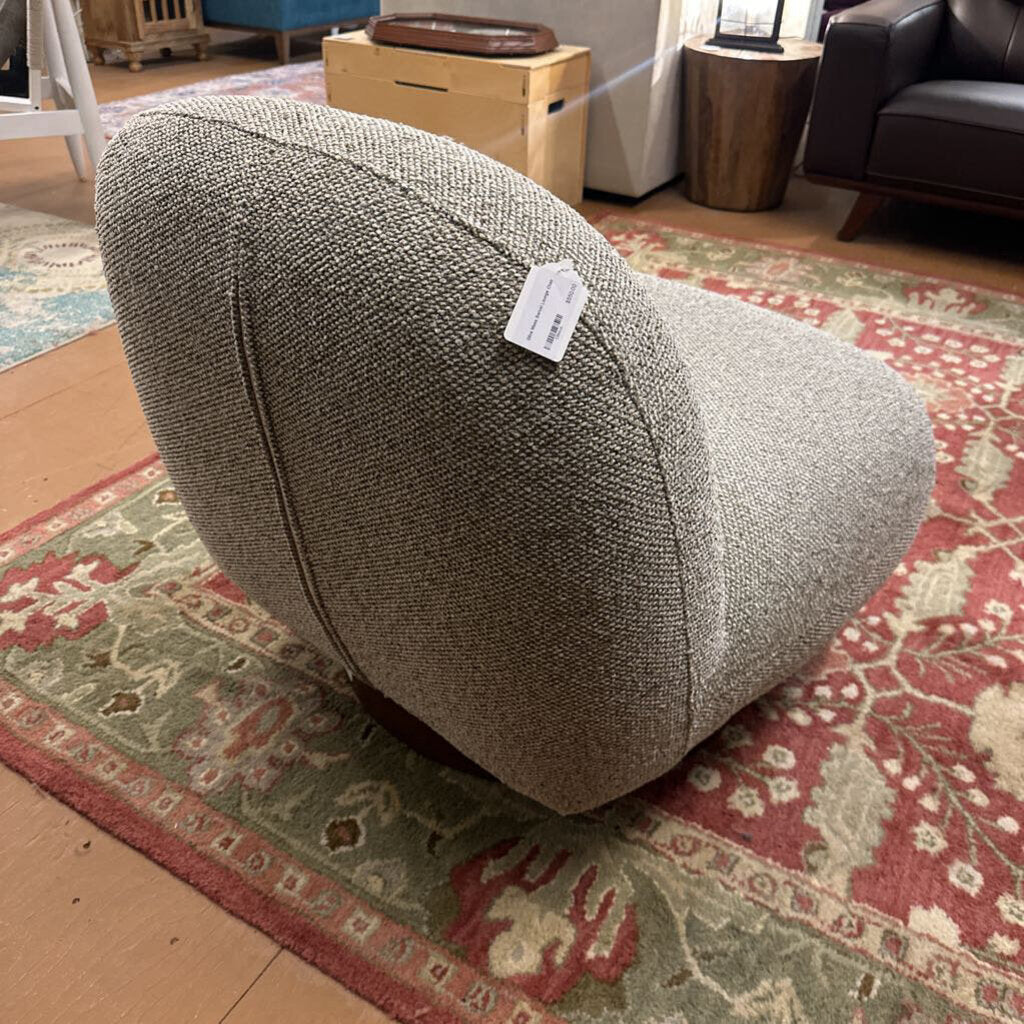Textured ottoman on a patterned rug with a price tag