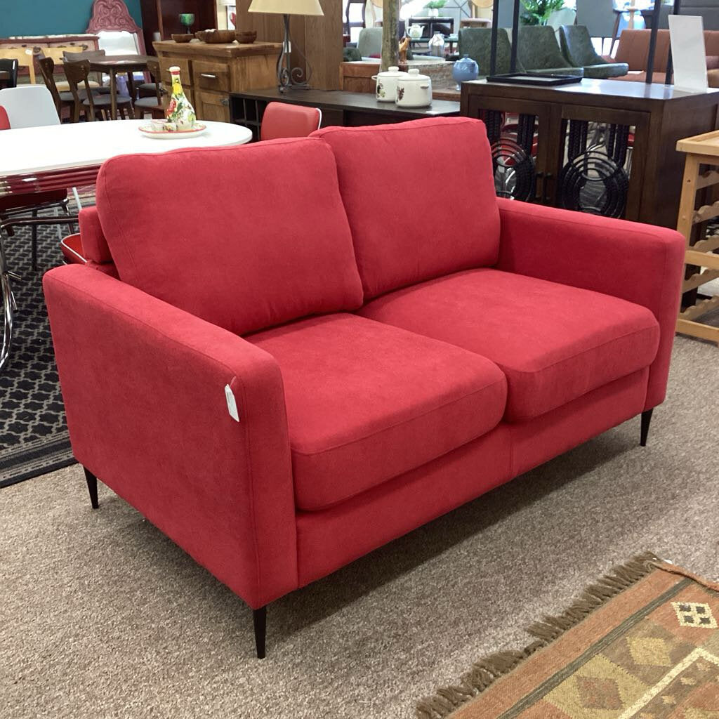 Red sofa in a room with furniture and decor