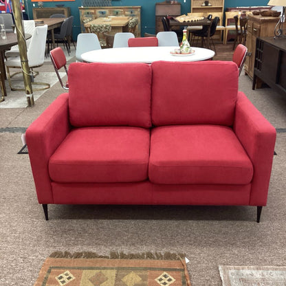 Red sofa in a showroom with other furniture in the background