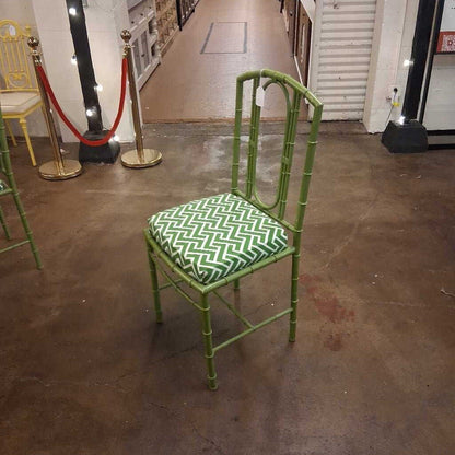 Green chair with a patterned cushion on a brown floor.