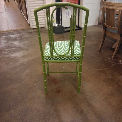 Green chair with a patterned seat on a concrete floor
