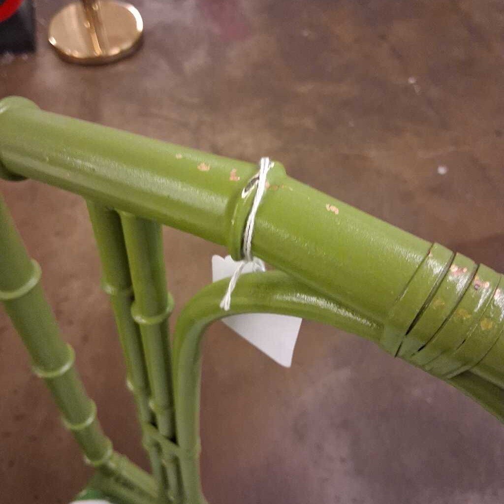 Green metal chair with a blurred background