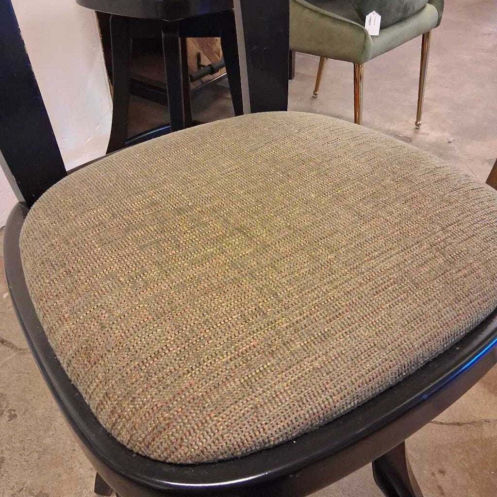 Textured chair seat cover on a chair with a blurred background