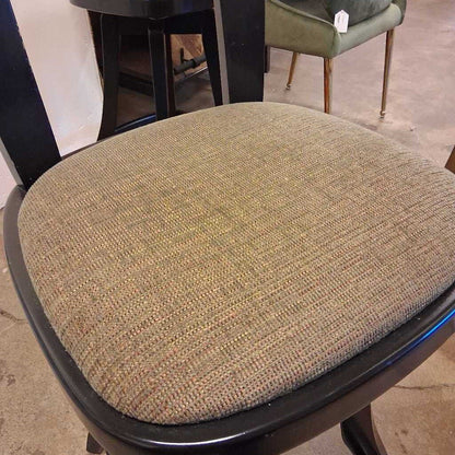 Textured chair seat cover on a chair with a blurred background