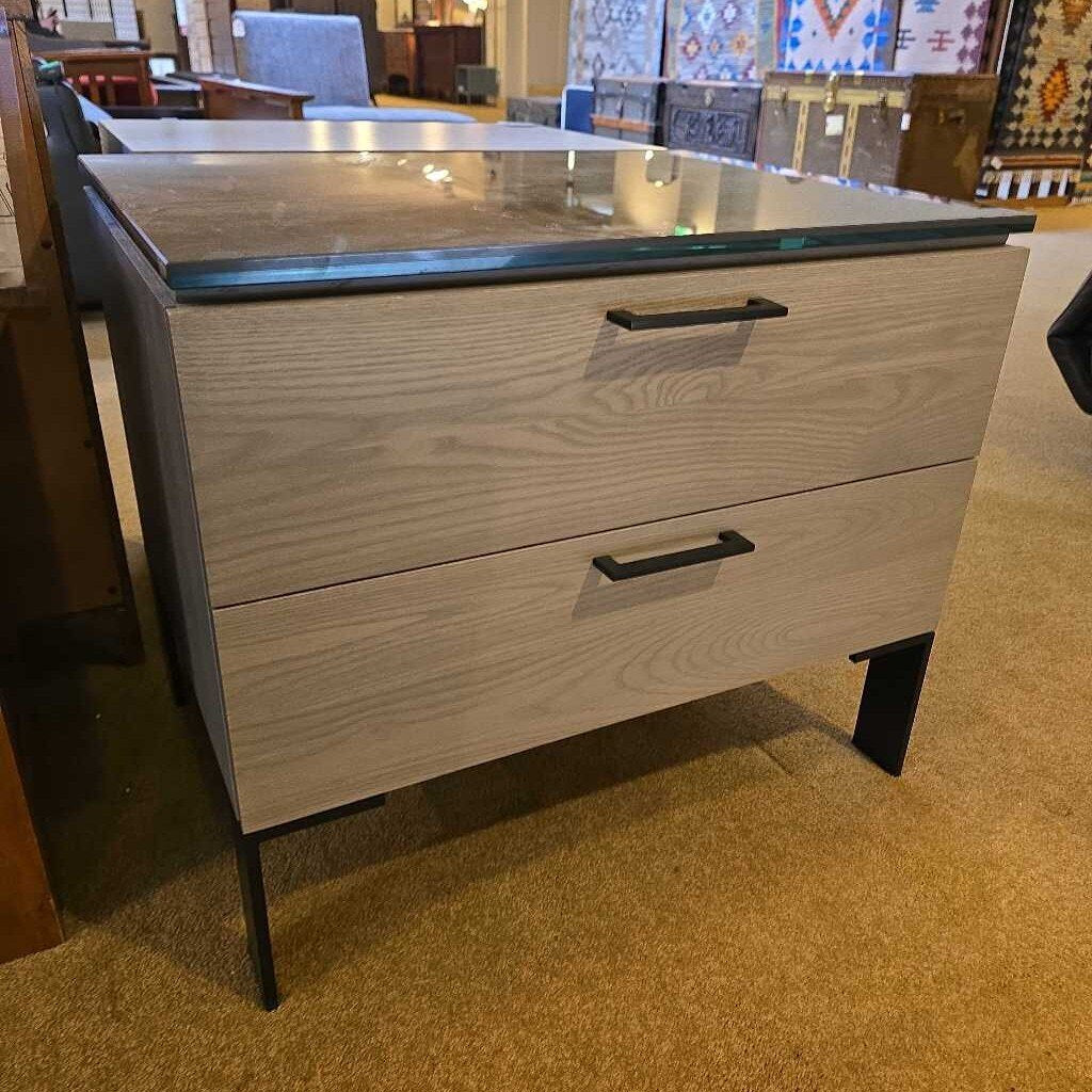 Wooden dresser with two drawers on a carpeted floor