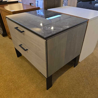 Small kitchen island with gray countertop and drawers in a room setting