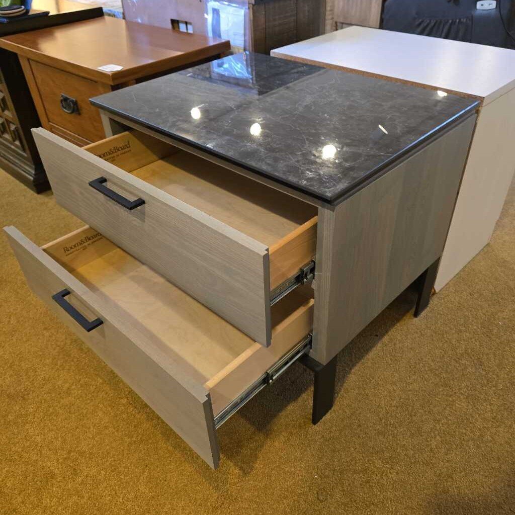 Kitchen island with open drawers and a gray countertop.