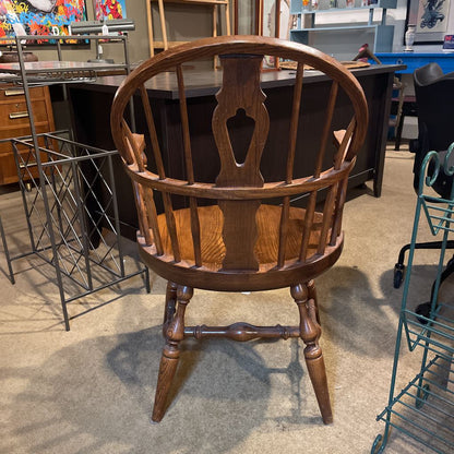 Wooden chair with a decorative backrest in an indoor setting