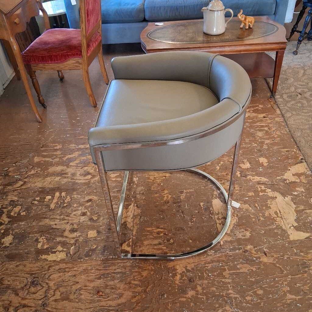 Gray chair with metal legs on a wooden floor