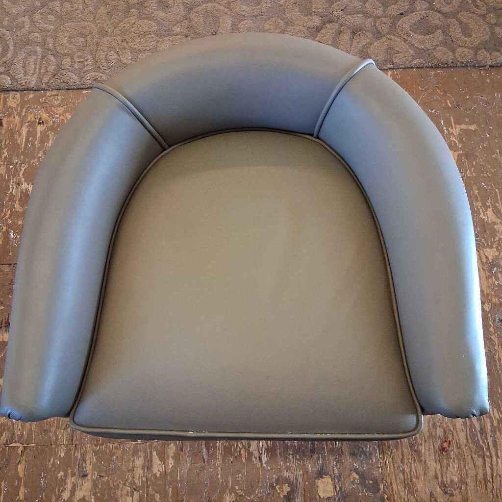 Gray leather car seat cover on a wooden surface