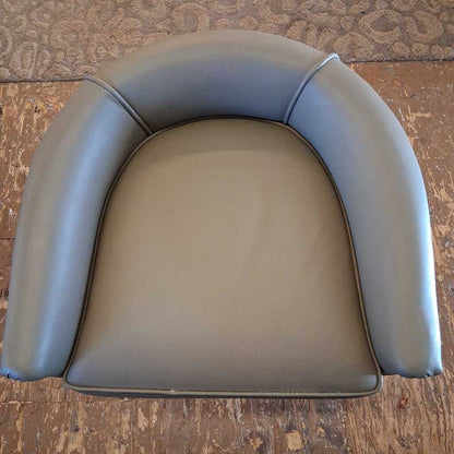 Gray leather car seat cover on a wooden surface