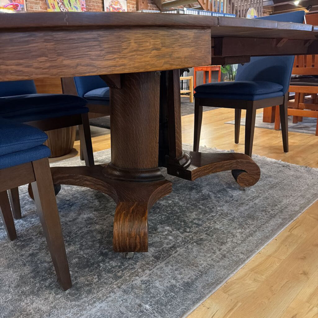Wooden dining table with chairs in a room setting