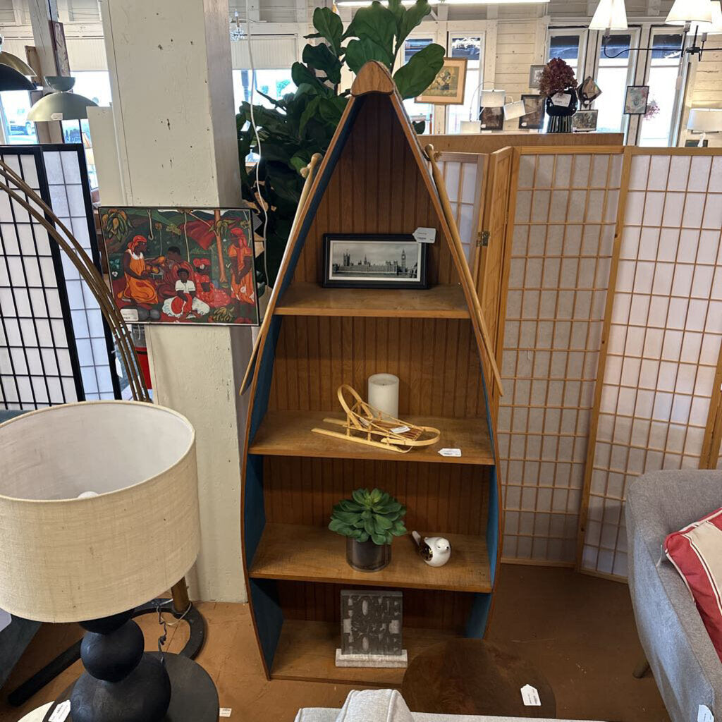 Wooden bookshelf with decorative items in a room setting