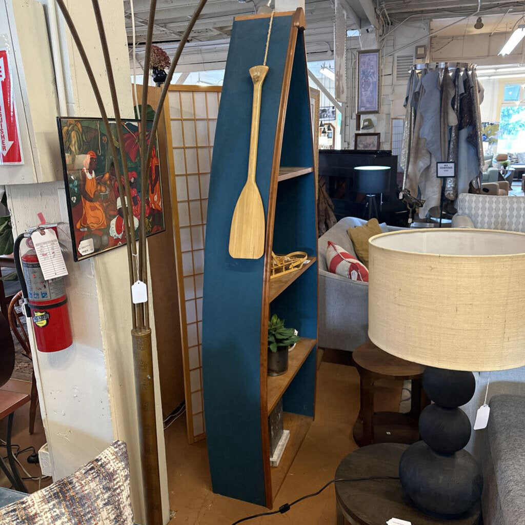 Blue bookshelf with a wooden paddle in a store setting