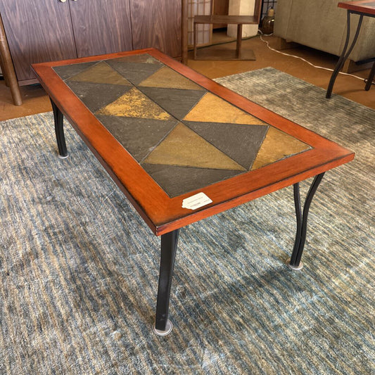 Coffee table with a geometric pattern on a carpeted floor