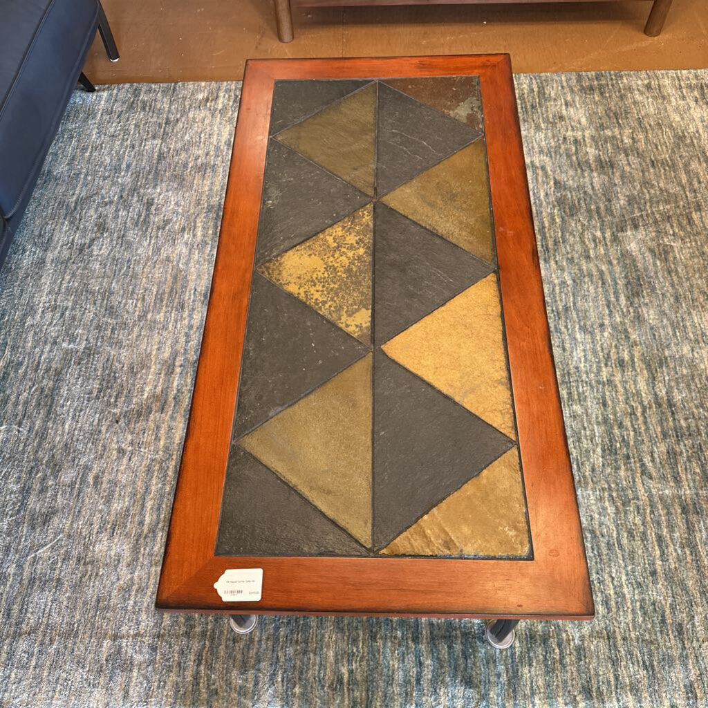 Rectangular coffee table with a geometric pattern on a textured carpet