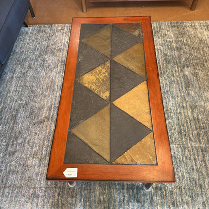 Rectangular coffee table with a geometric pattern on a textured carpet