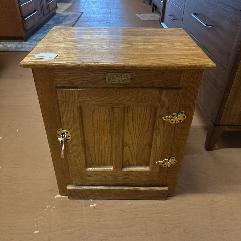 Wooden cabinet with a visible brand name on a wooden floor.