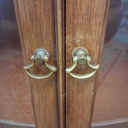 Wooden cabinet with brass handles on a blurred background