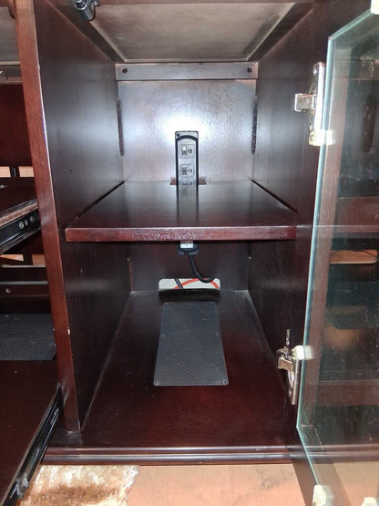 Wooden cabinet with a power outlet on a wooden floor